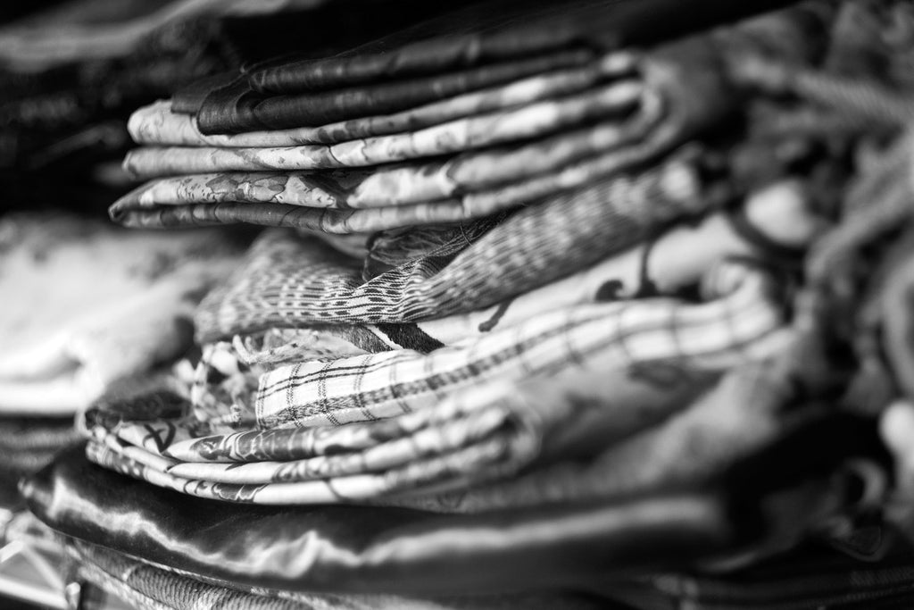 Close-up of a stack of folded textiles in Andrea Aranow's studio. 